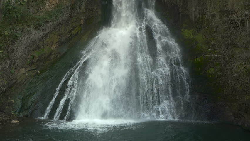 Waterfall cascade on mountain rocks