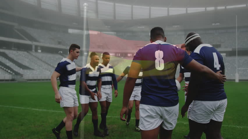 On field, rugby team huddling with animation of flag overlay in background. teamwork, unity, sports, athletes, national, strategy