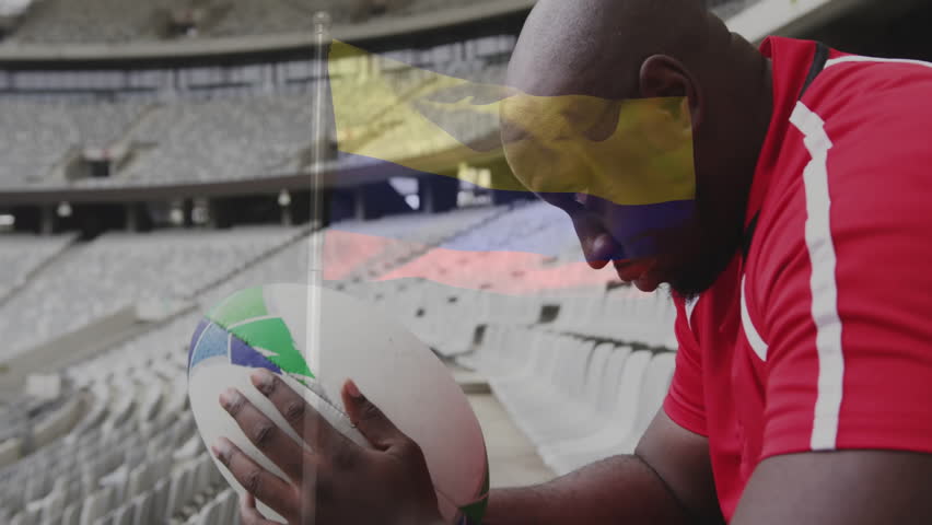 Holding rugby ball, player in empty stadium with flag animation overlay. Sports, athlete, competition, game, determination, athletics
