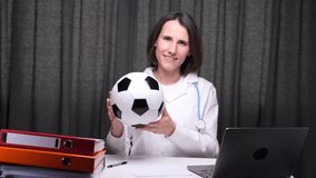Female doctor holding soccer ball in medical office - Powered by Shutterstock - Get 15% off with code: PIKWIZARD15