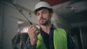 Caucasian man talking walkie talkie male architect engineer contractor builder in hard hat safety vest repairman guy speaking remote radio building foreman communication manager worker construction - Powered by Shutterstock - Get 15% off with code: PIKWIZARD15