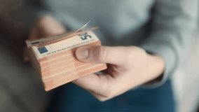 Close-up hands presenting euro banknotes, signifying wealth, financial planning, and income management within the euro currency framework. - Powered by Shutterstock - Get 15% off with code: PIKWIZARD15