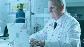 Working on laptop, elderly scientist with animation of social media icons. Technology, research, innovation, connectivity, networking, digital - Powered by Shutterstock - Get 15% off with code: PIKWIZARD15