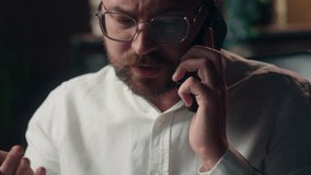 Serious Caucasian guy executive business boss discussing startup mobile phone in office businessman agent writing notes male worker typing laptop multitask man employee searching data broker planning - Powered by Shutterstock - Get 15% off with code: PIKWIZARD15