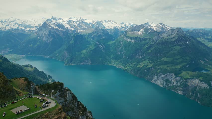 Snowy rocky mountains in Swiss Alps and lake Lucerne from bird
