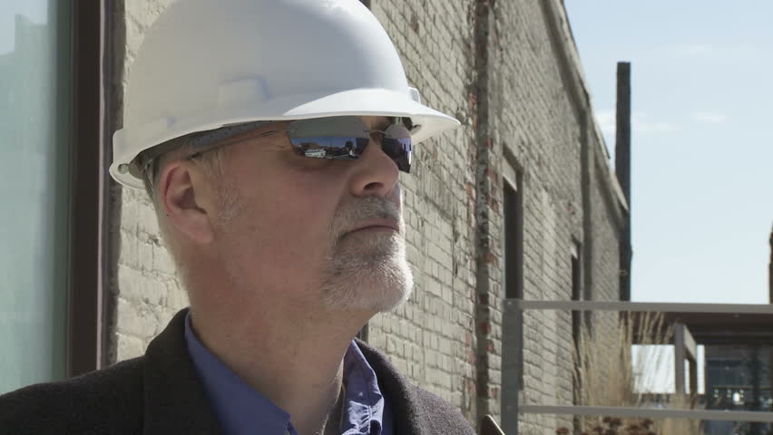 Close up of building contractor, workman or site inspector, wearing sunglasses