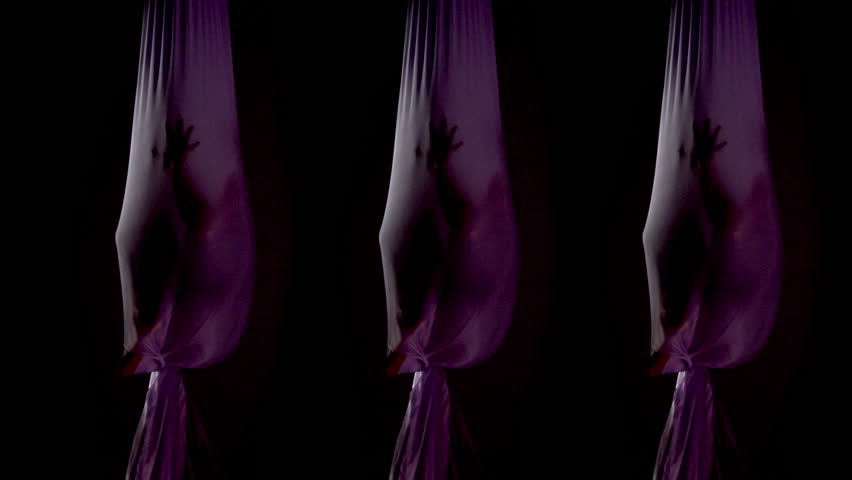 Multiple shot of aerial yoga practitioner sitting in a silk hammock or nest.