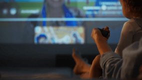 Young mother with baby in hand watching online broadcasts switching channels using remote control. Close-up of housewife's hand watching TV lying on sofa with small child - Powered by Shutterstock - Get 15% off with code: PIKWIZARD15