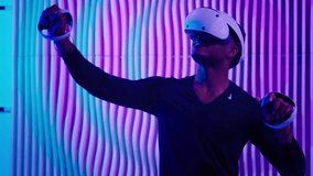 Smiling happy African American man in VR glasses play virtual reality game in neon futuristic space browsing interactive future software interface guy male cyberpunk innovate simulation helmet working - Powered by Shutterstock - Get 15% off with code: PIKWIZARD15