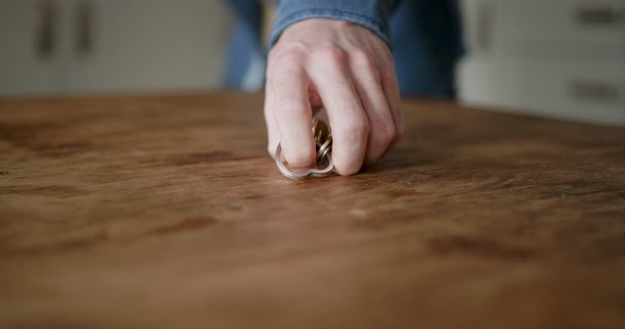Close-up of Person picking up Keys on Table, leaving for Work