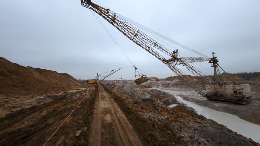 Dragline excavator working at titanium dioxide mining and processing plant captured by FPV drone
