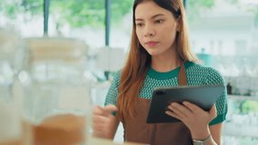 Eco friendly shop owner using digital tablet to check bio organic products stock in container dispenser at plastic free grocery store. Sustainable small local business SME startup go green market. - Powered by Shutterstock - Get 15% off with code: PIKWIZARD15