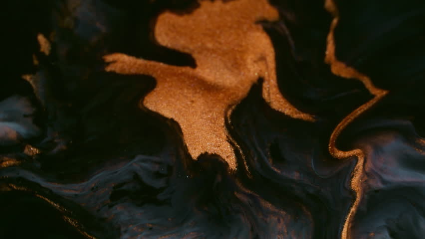 Art magma. Shimmering explosion. Orange golden paint lava eruption volcano. Molten mass spread mix across black liquid abstract background.