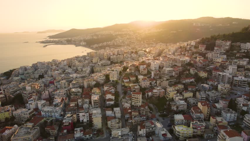 Kavala Greece aerial footage of City center buildings and coast, evening Golden hour lighting