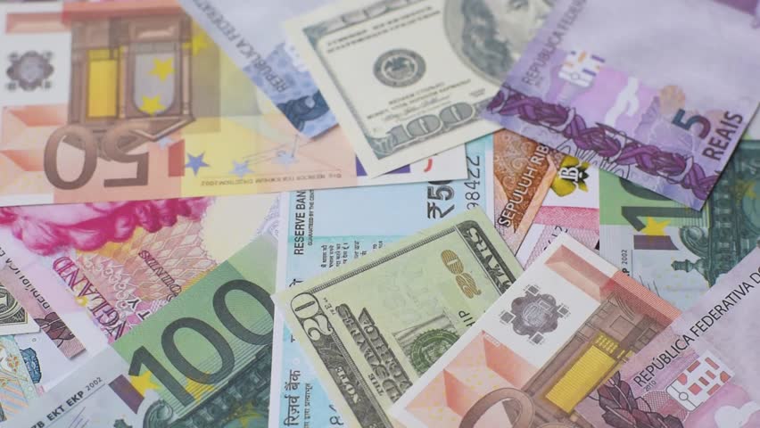 A background consisting of paper banknotes of different currencies of the USA, Europe, Brazil. Multicurrency background