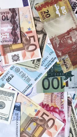 A background consisting of paper banknotes of different currencies of the USA, Europe, Brazil. Multicurrency background