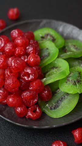 Dried sweet green kiwi or candied fruit on dark concrete background