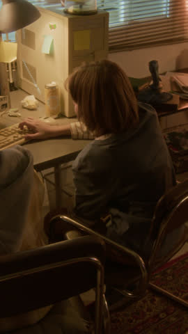 Vertical Arc shot of two children doing high five while playing retro videogames together in 90s setting