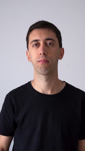 Caucasian Man Signaling Silence, Gesturing With Finger On His Lips And Mouth Zipped. vertical shot