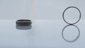 Wedding rings rolling on table in slow motion, wedding day - Powered by Shutterstock - Get 15% off with code: PIKWIZARD15