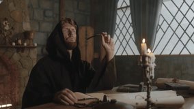 Medieval monk writing historic manuscripts at table - Powered by Shutterstock - Get 15% off with code: PIKWIZARD15