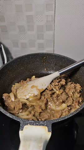 shows cooking on a hot skillet in the form of meat