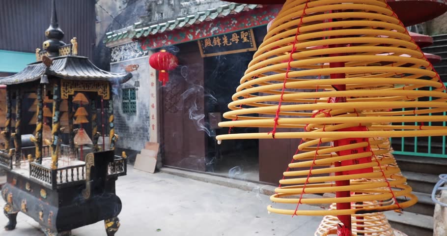 Spiral hanging insence burning in the chinese temple in Macau. Translation: Buddhist temple