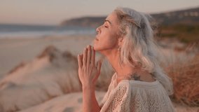 A mature woman with grey hair meditates on a peaceful beach, embracing mindfulness and serenity at sunset. - Powered by Shutterstock - Get 15% off with code: PIKWIZARD15