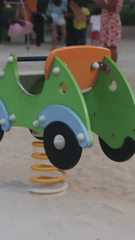 A playground with a spring rider car.