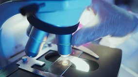 Gloved hands meticulously adjust microscope lenses, illuminating a sample slide with focused beams of light, highlighting the precision and focus of scientific research - Powered by Shutterstock - Get 15% off with code: PIKWIZARD15