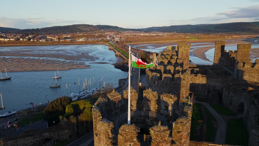 Golden Hour of Conwy Castle and Welsh Flags, River Conwy Estuary and Bridge, North Wales