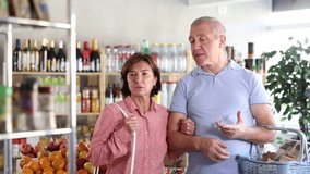 Senior family couple is looking for fresh produce together in a grocery supermarket. High quality 4k footage - Powered by Shutterstock - Get 15% off with code: PIKWIZARD15