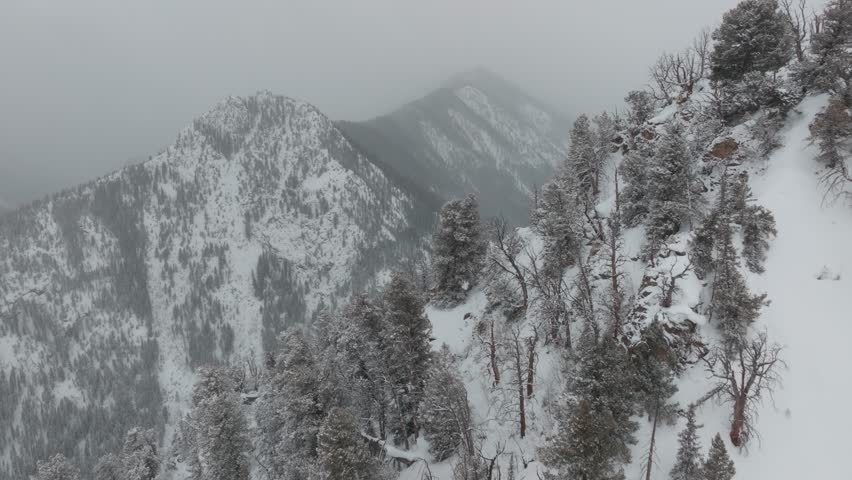 Aerial footage of the Rocky Mountains in Colorado during a heavy snowstorm.