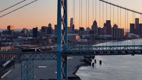 Semi truck passing Ambassador Bridge during sunset, export and import concept, aerial view - Powered by Shutterstock - Get 15% off with code: PIKWIZARD15