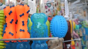 close up of woman's hand selecting rubber bone dog toys, touching them and taking one out. Toys in a dog store. Joy for a pet. - Powered by Shutterstock - Get 15% off with code: PIKWIZARD15