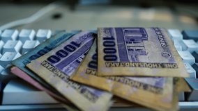 Bangladeshi Taka Banknotes on Keyboard, A pile of Bangladeshi Taka banknotes on a computer keyboard, symbolizing online transactions or digital finance - Powered by Shutterstock - Get 15% off with code: PIKWIZARD15