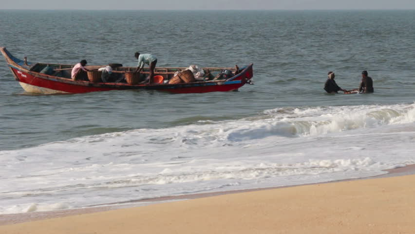 ALLEPEI, INDIA - DECEMBER 04, 2012: Fishermen unload fresh catch of fish on
