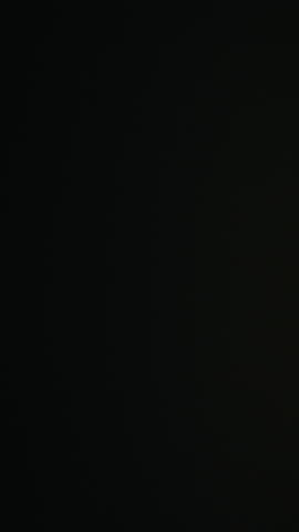 Fast-moving streaks of yellow city lights create a dynamic blur against the nighttime backdrop