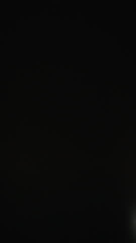 Swish pan through vibrant city lights at night, creating dynamic motion blur and streaking neon trails