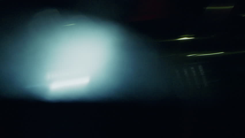 A chaotic spin of neon light trails distorts the urbanscape into a hypnotic illusion of speed through a whip pan shot