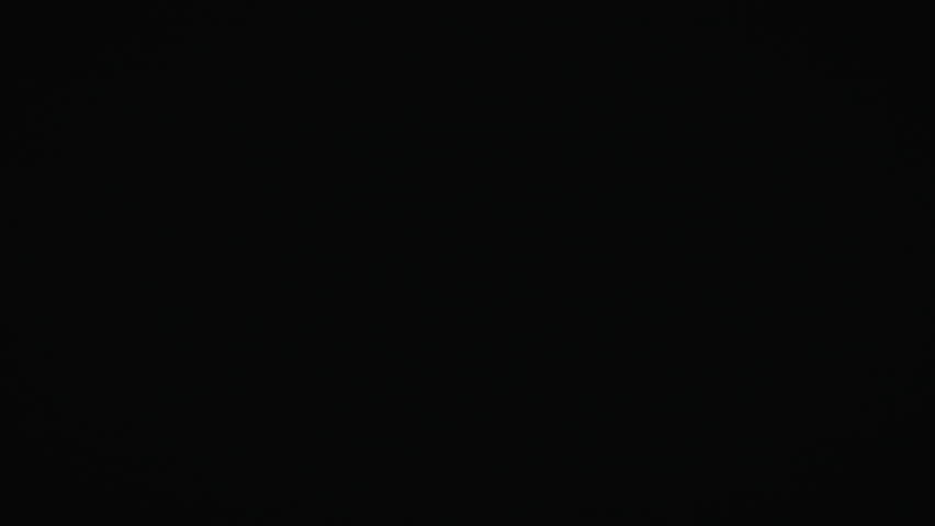 A rapid whip pan of neon light trails at night, capturing radiant hues of yellow in a speeding illusion