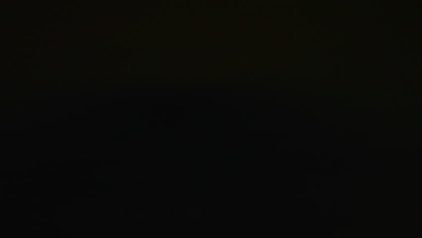 Dynamic whip pan capturing vibrant neon lights in motion, creating an abstract and energetic night transition with streaking colors