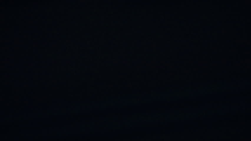 A rapid whip pan sweeps through a vibrant night cityscape, creating dynamic streaks of neon lights and motion blur for a seamless, high-energy transition