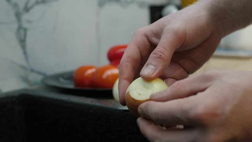 Intricate process of peeling onions, showcasing precise slicing and meticulous preparation in a lively kitchen, with fresh tomatoes beautifully arranged in the background