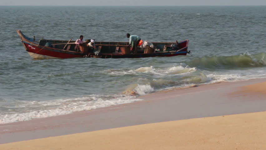 ALLEPEI, INDIA - DECEMBER 04, 2012: Fishermen unload fresh catch of fish on