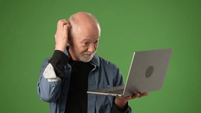 A senior man demonstrates frustration while viewing his laptop screen isolated on green screen background. He appears to be tracking business data or evaluating performance. - Powered by Shutterstock - Get 15% off with code: PIKWIZARD15