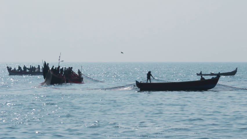 fishermen in boats pulling fishing nets - Kerala India