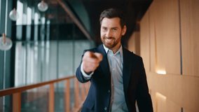 Successful businessman walking corridor modern company pointing finger to camera closeup. Confident bearded boss smiling buttoning elegant jacket. Luxurious happy executive going office hallway alone. - Powered by Shutterstock - Get 15% off with code: PIKWIZARD15