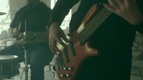 Muscular rock band members performing intense musical collaboration inside dilapidated industrial space, generating powerful rhythmic energy through bass guitar and drum interaction - Powered by Shutterstock - Get 15% off with code: PIKWIZARD15