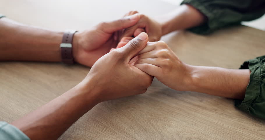 Forgiveness, holding hands or empathy and people in home together with support for grief, loss or pain. Comfort, love and trust with friends closeup in apartment for compassion, help or patience